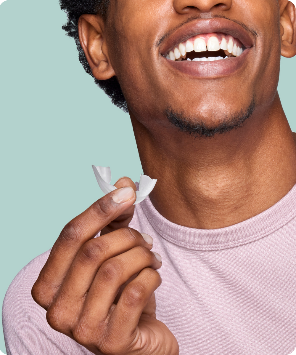 Man Smiling Holding Opal Classic Prefilled Whitening Tray