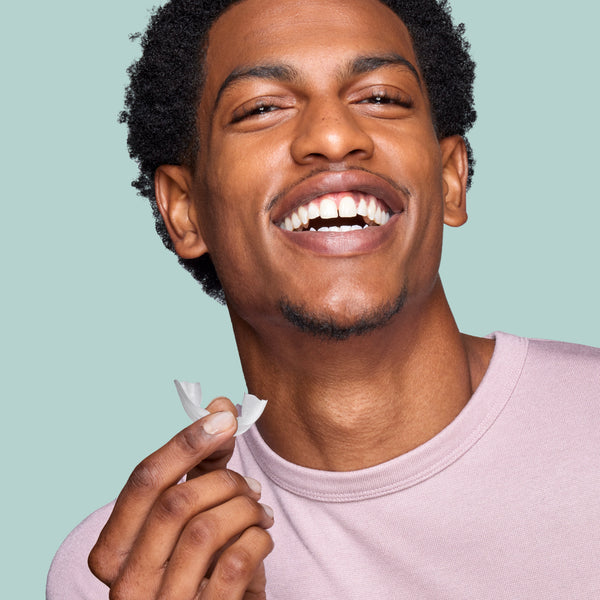 Man Smiling Holding Opal Prefilled Whitening Tray